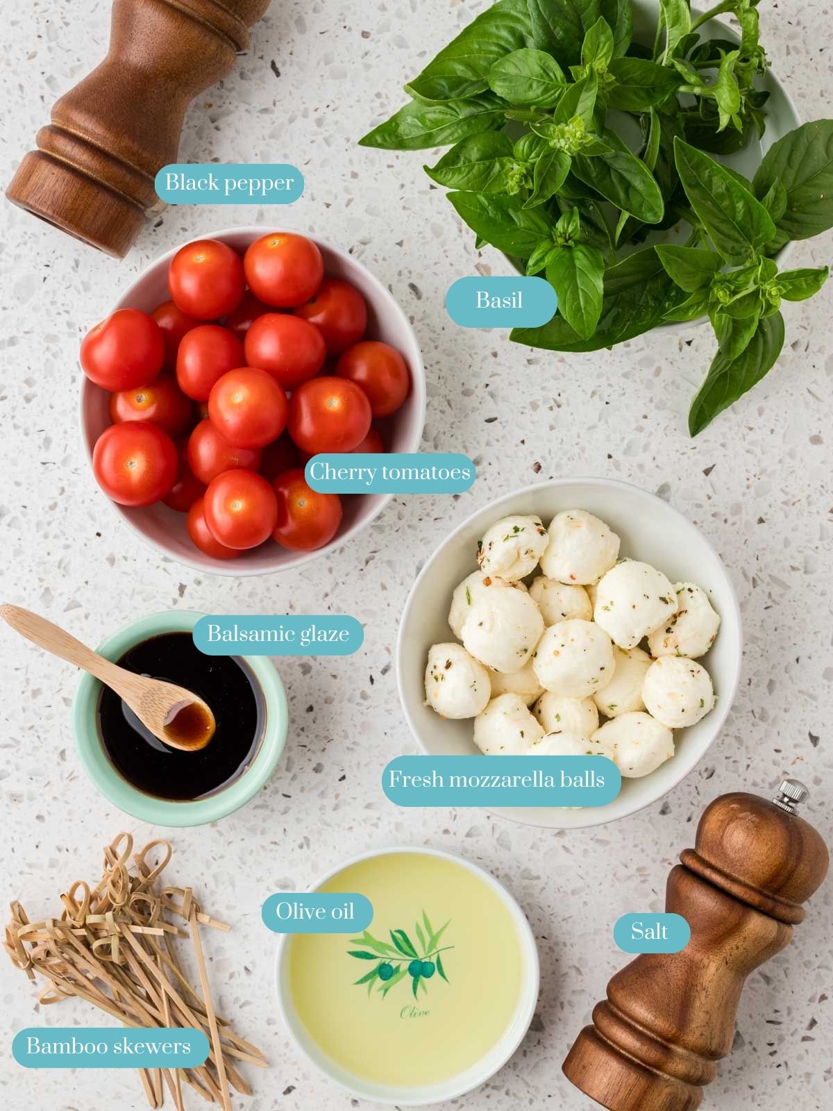 Ingredients for Caprese Salad Skewers. Ingredients include cherry tomatoes, mozzarella balls, fresh basil leaves, olive oil, balsamic glaze, salt and pepper. 