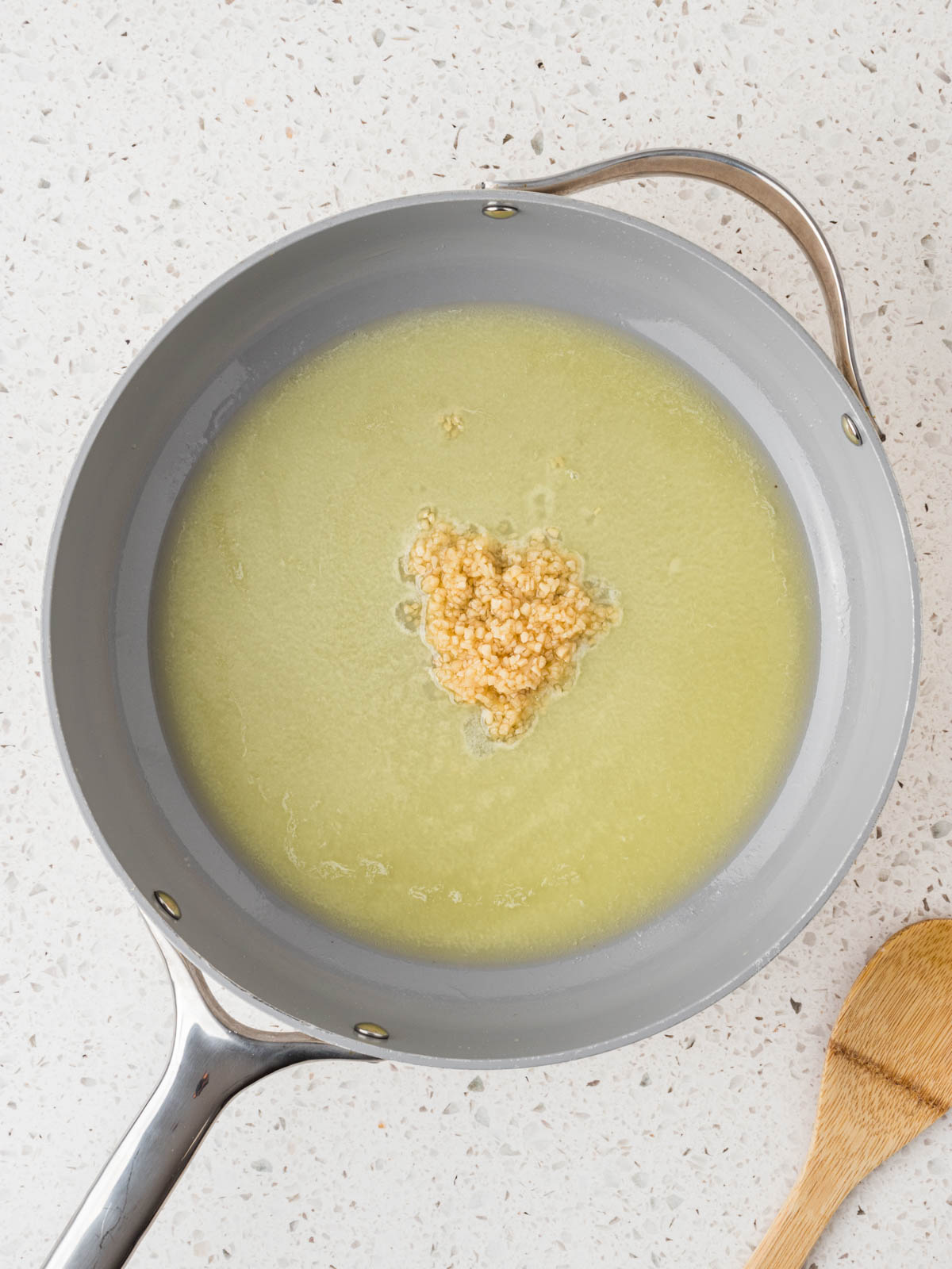 Melted butter in a pan with minced garlic.