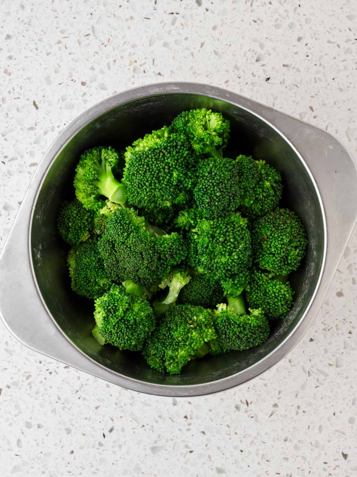 Steamed broccoli in a colander. 
