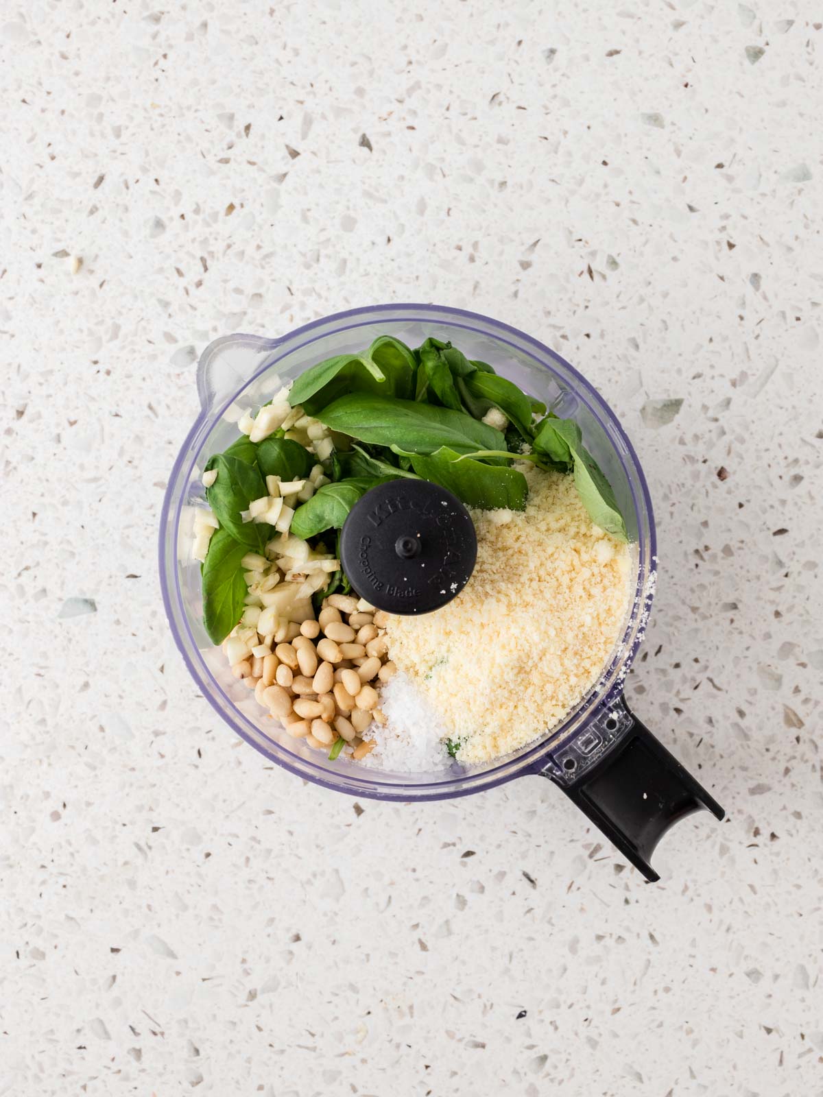 Fresh basil leaves, toasted pine nuts, grated Parmesan, garlic, and, kosher salt in a food processor. 