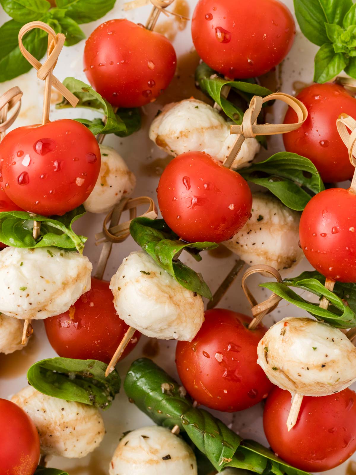 Caprese skewers stacked on top of one another filling the entire frame of the picture. 