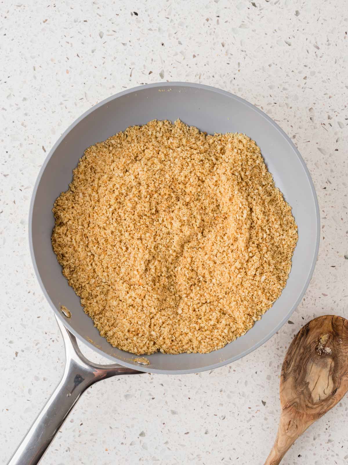Toasted breadcrumbs in a skillet with olive oil. 