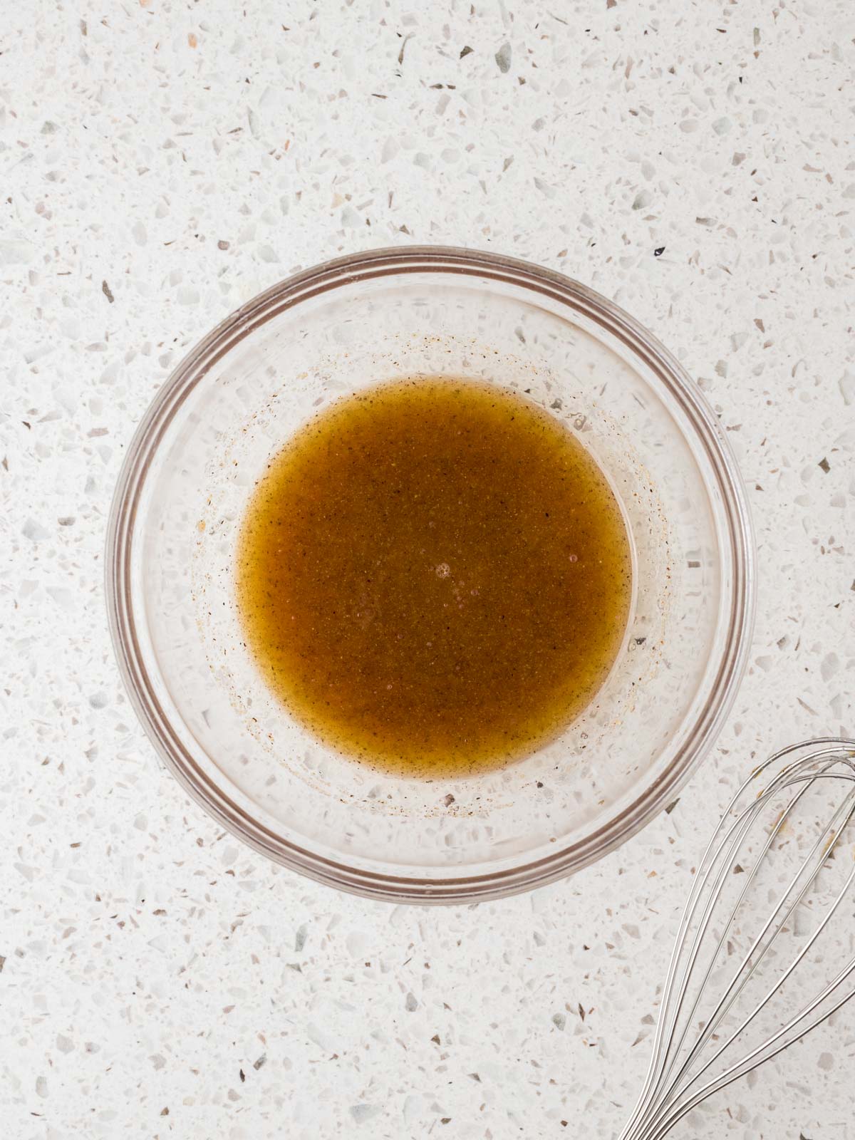 Extra virgin olive oil, red wine vinegar, garlic powder and the juice of one lemon whisked together in a small glass bowl. 
