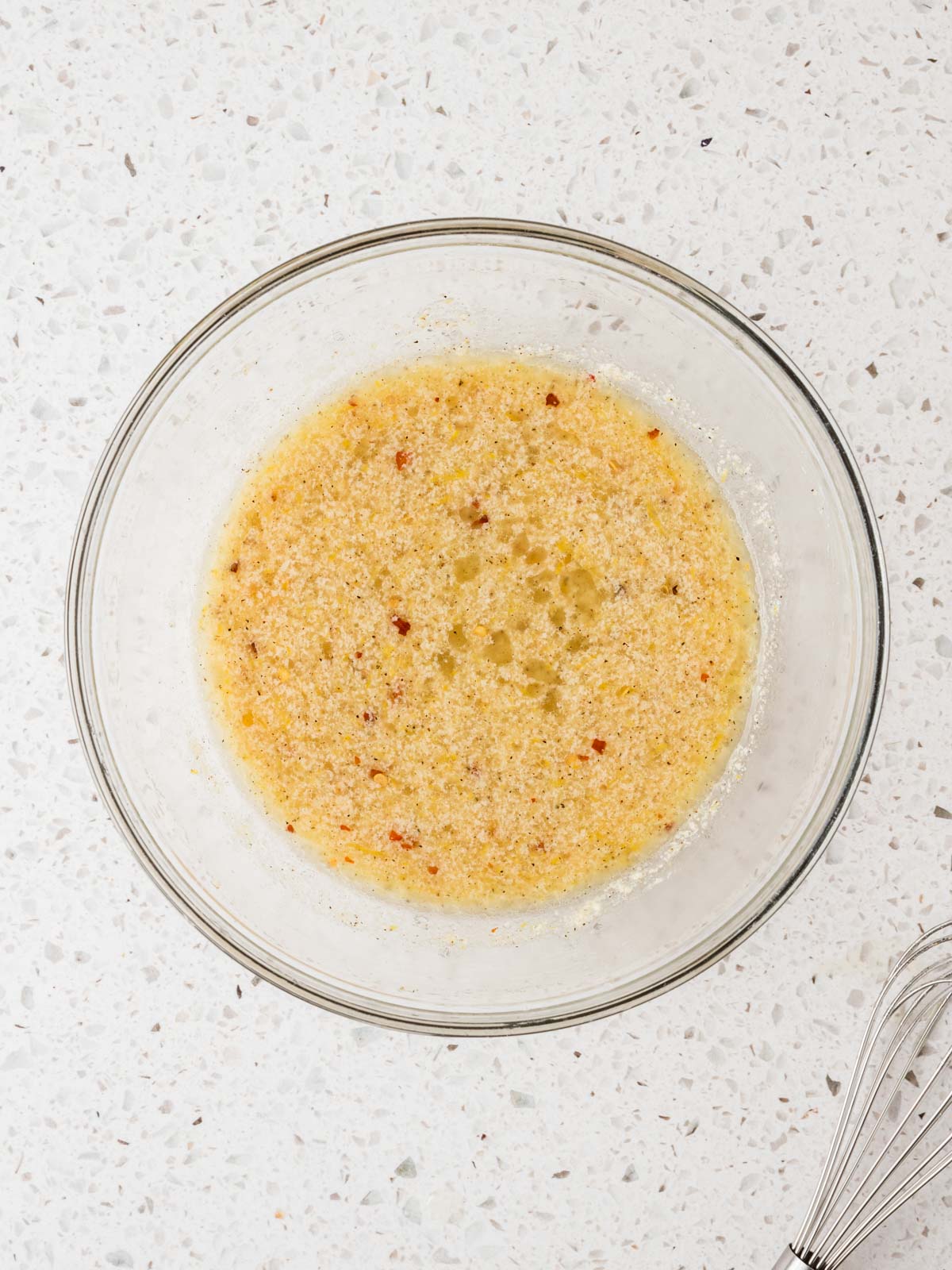 Lemon juice, olive oil, parmesan and all seasonings whisked together in a small bowl.