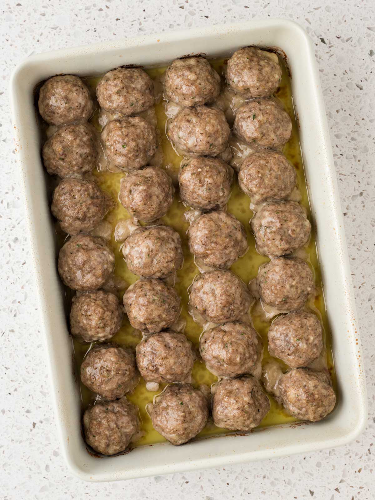 Cooked meatballs in a baking dish ready to serve.