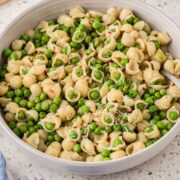 Pasta with peas in a serving bowl.