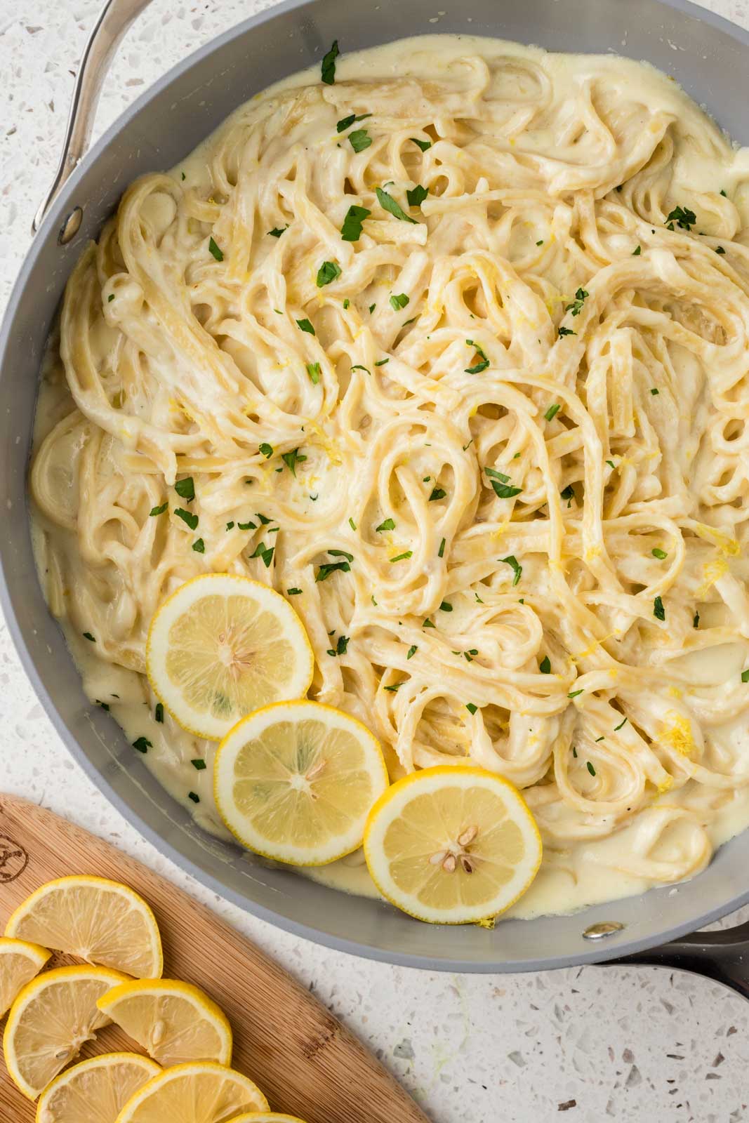 Lemon Fettucine in a pan garnished with sliced lemons.