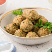 Italian Chicken Meatballs in a serving bowl garnished with parsley.