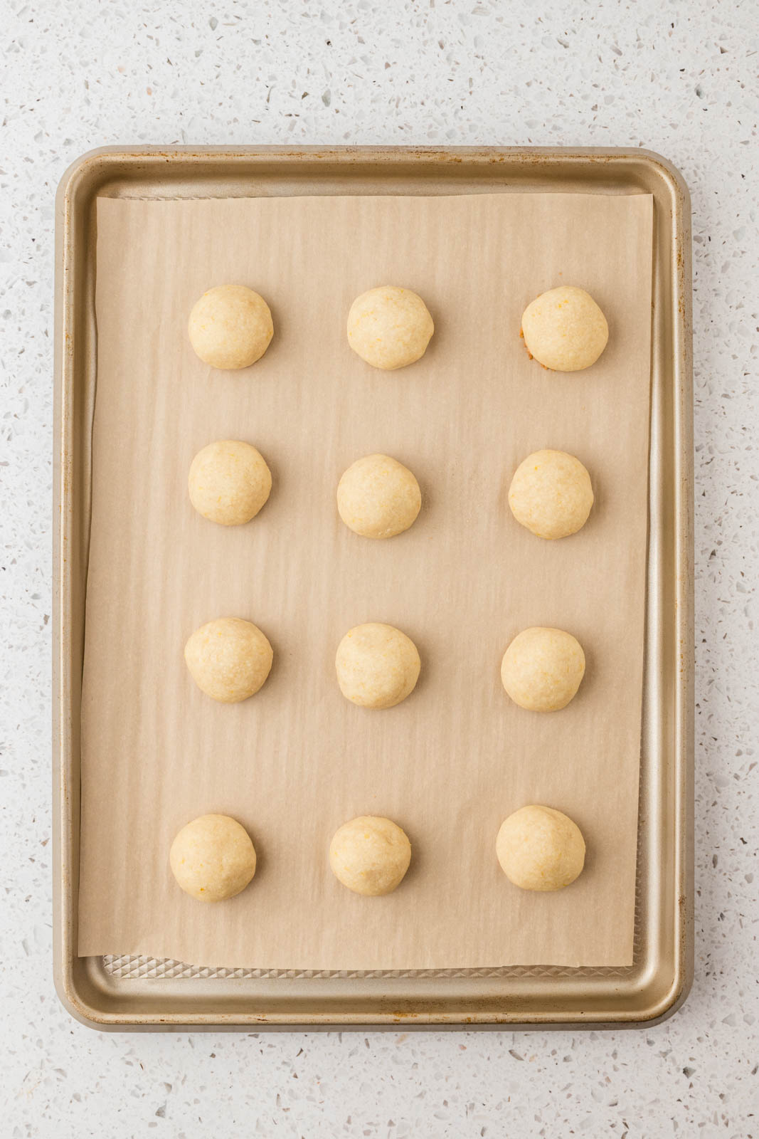 Lemon snowball cookies baked on a cookie sheet.