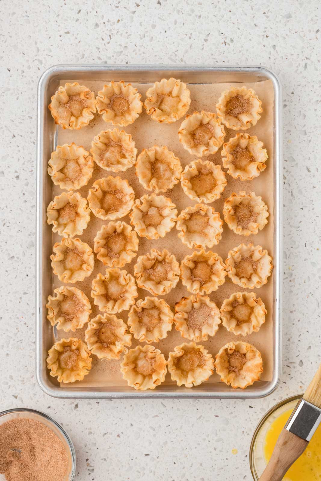 Phyllo shells brushed with egg wash and dusted with cinnamon sugar mixture.