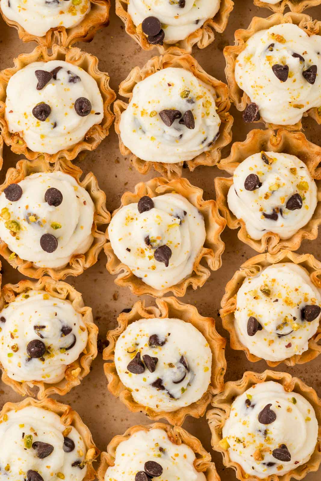 Cannoli Bites on a parchment lined baking sheet.
