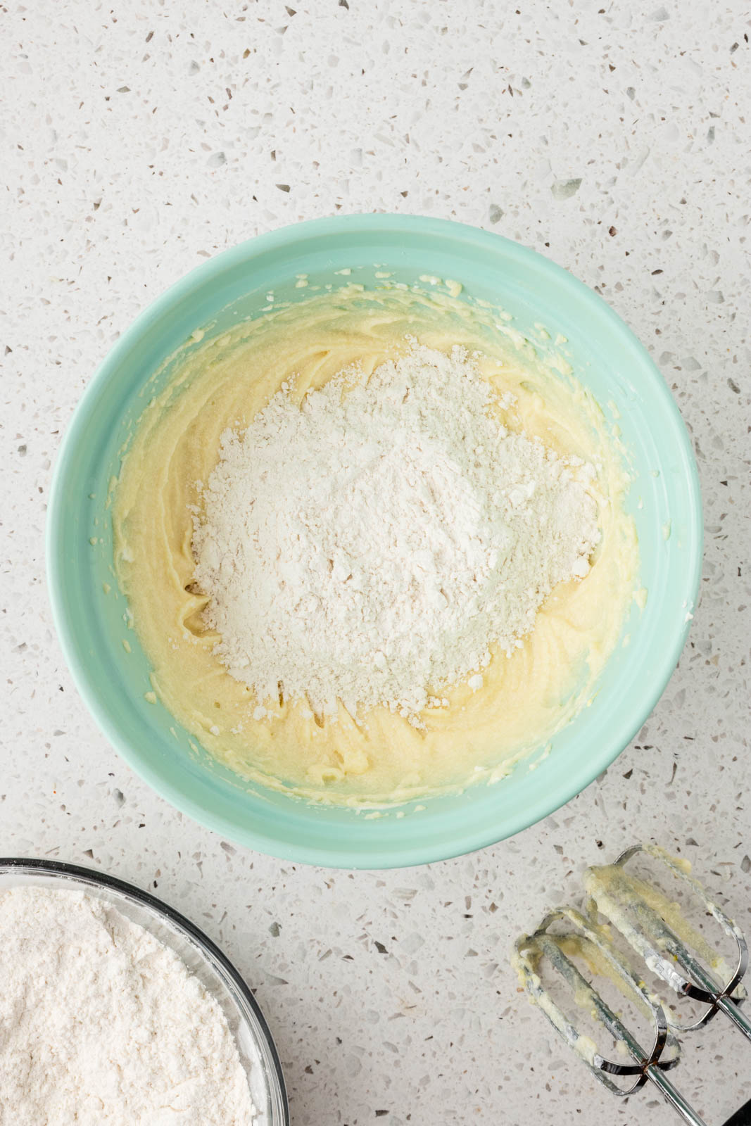 Add all purpose flour gradually to mixing bowl.