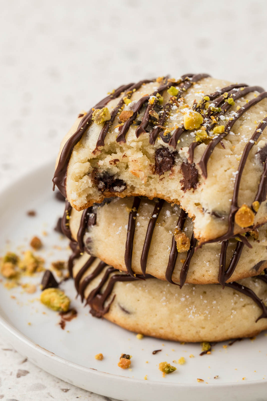 Cannoli cookies stacked with a bite taken out of the top cookie.