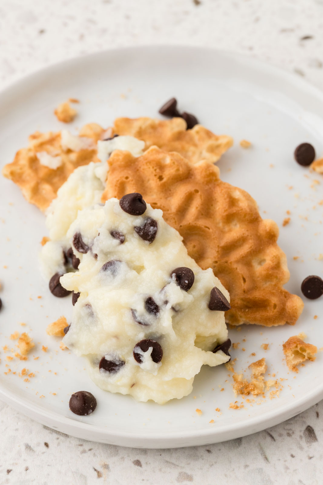 Cannoli Dip on a piece of broken pizzelle cookie.