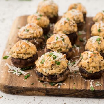 Italian stuffed mushrooms on a wooden board.