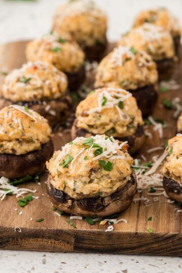 Italian stuffed mushrooms on a wooden board.