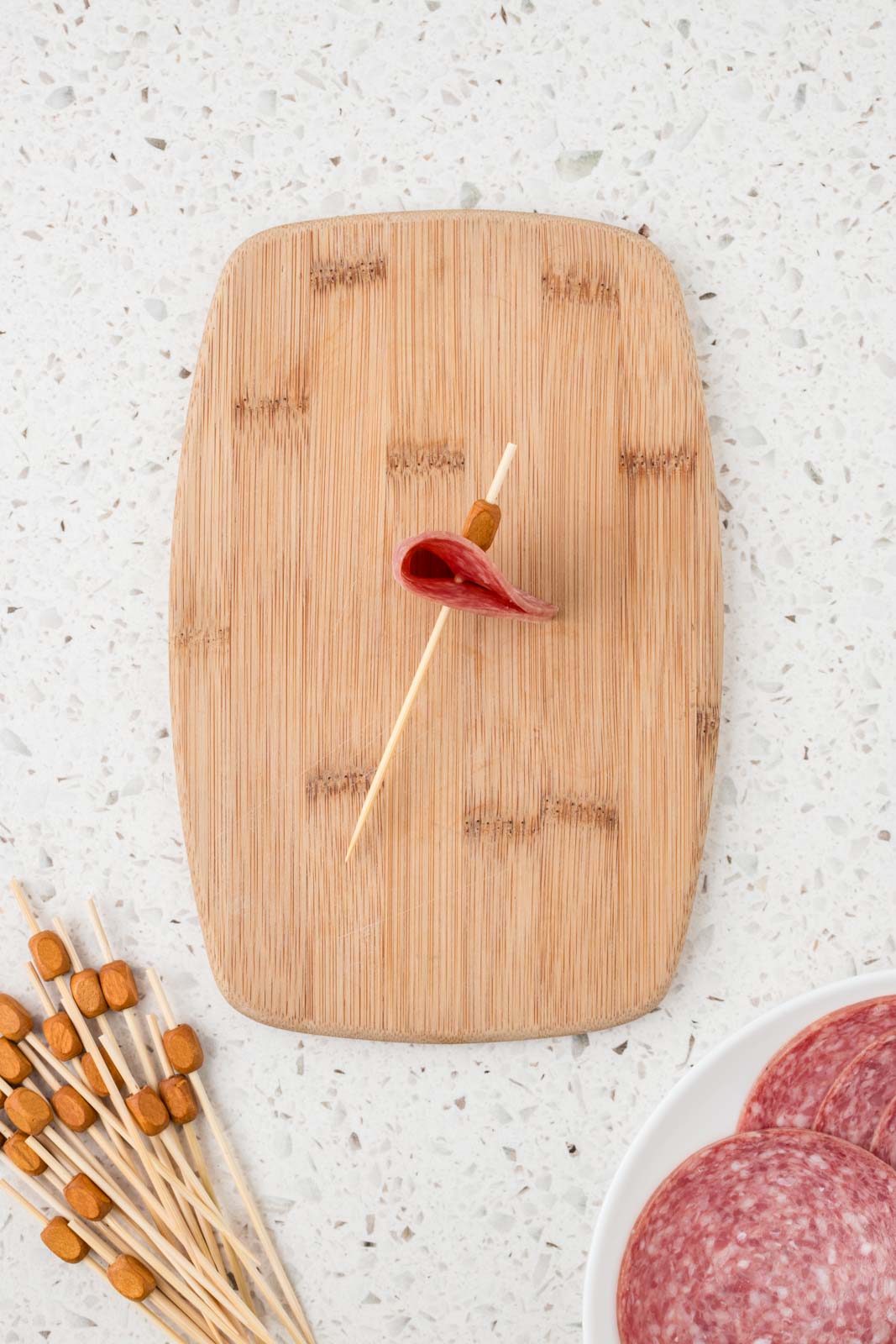 Skewer with salami threaded onto the end.