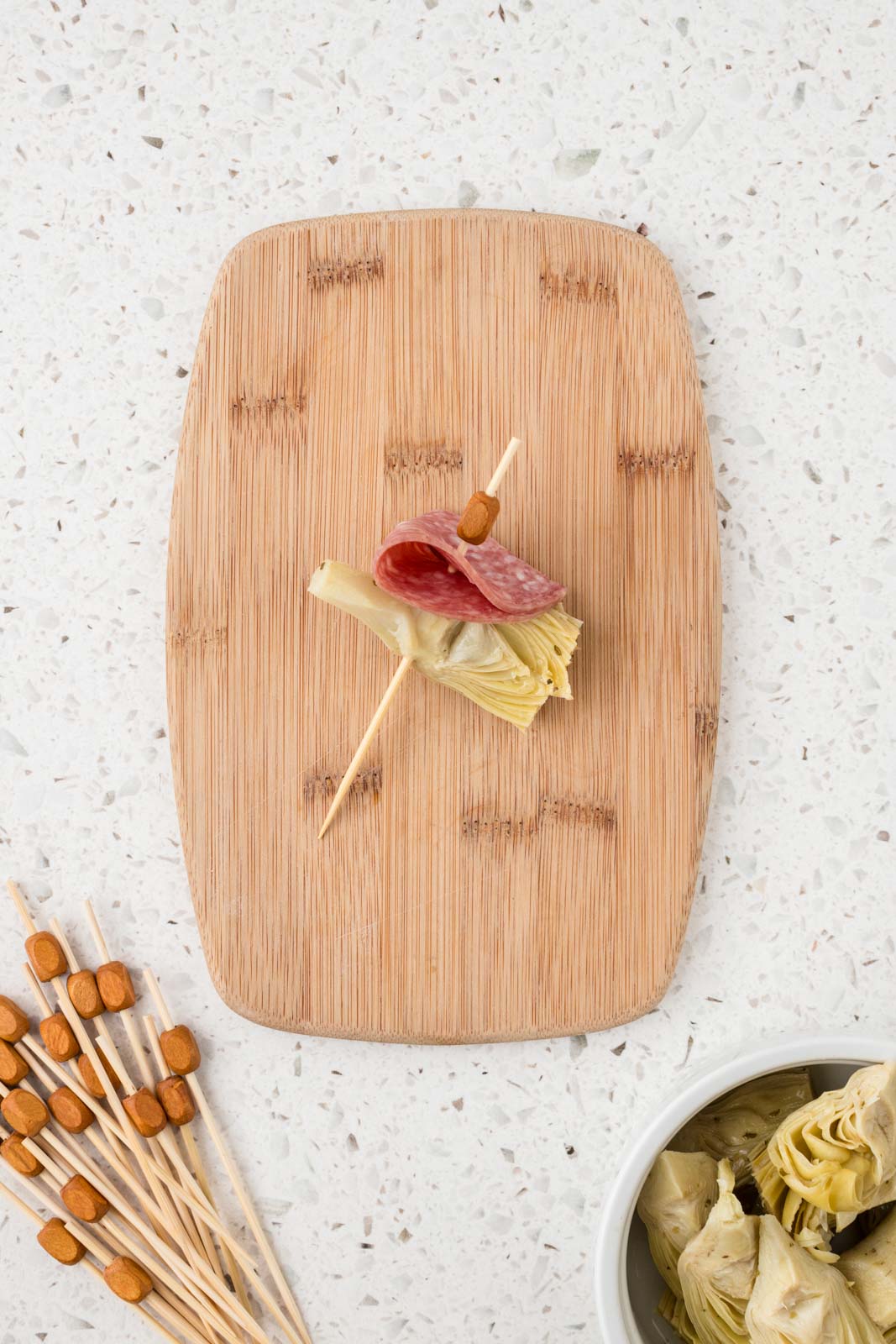 Mini antipasto skewer with artichoke heart threaded on the end.