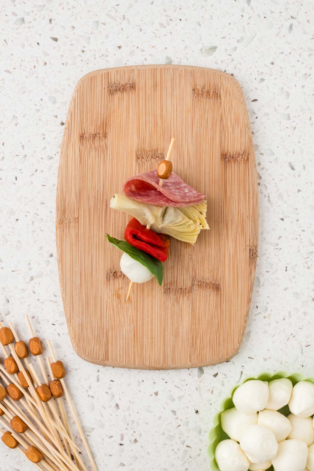Mini antipasto skewer with mozzarella ball added to the end.