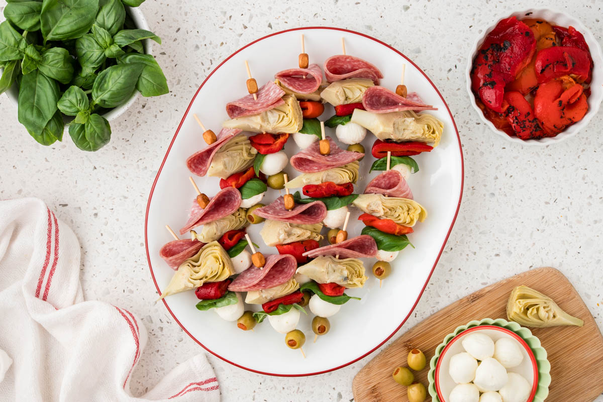 Mini antipasto skewers on a platter.