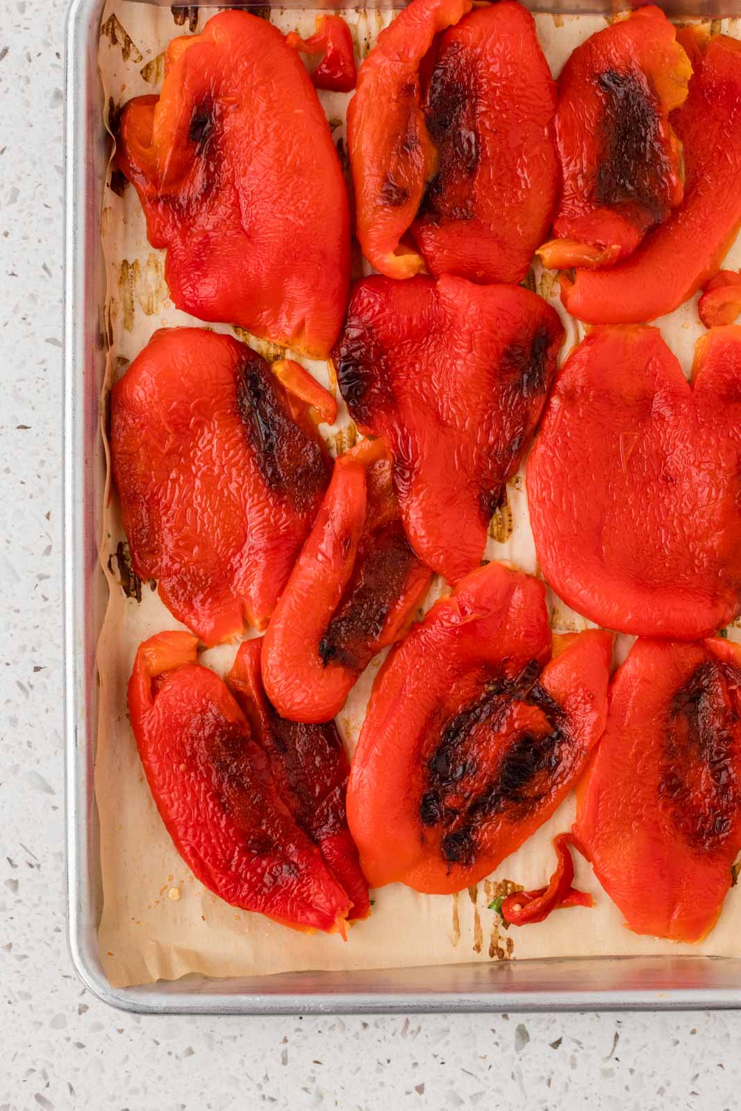 Roasted red pepper on a baking sheet.