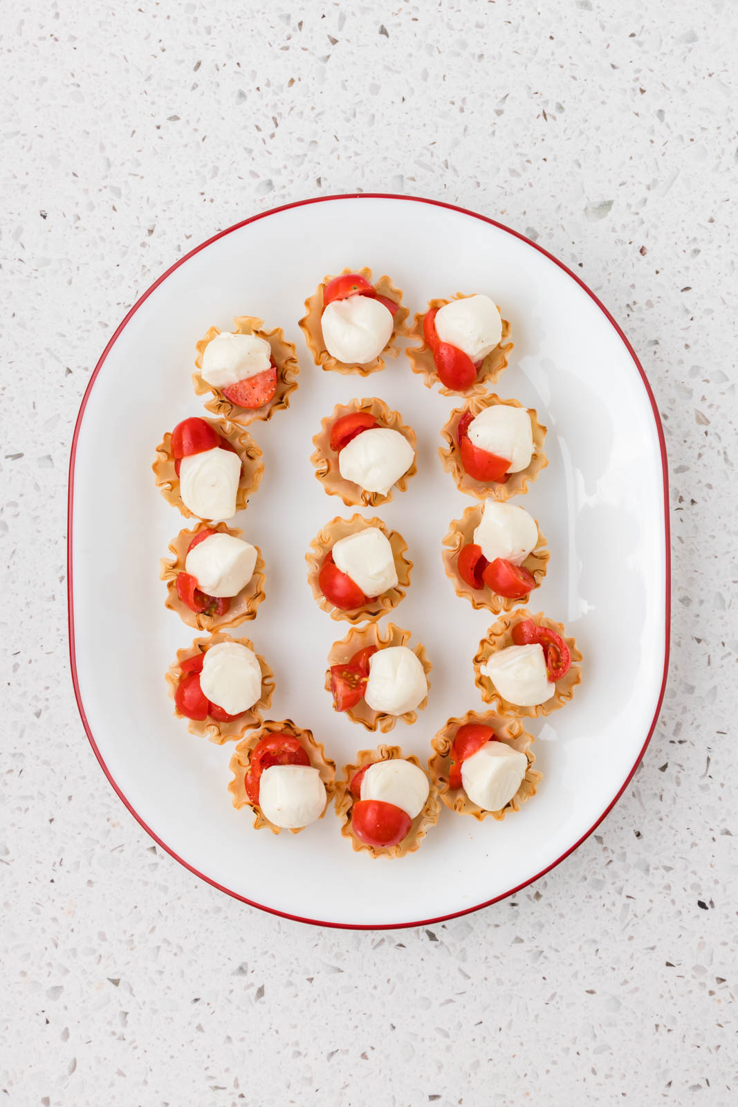 Mozzarella balls added to phyllo cups.