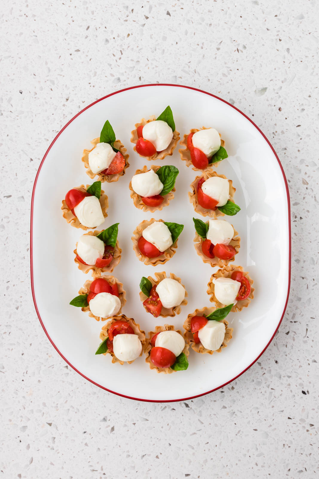 Caprese cups assembled on a platter.