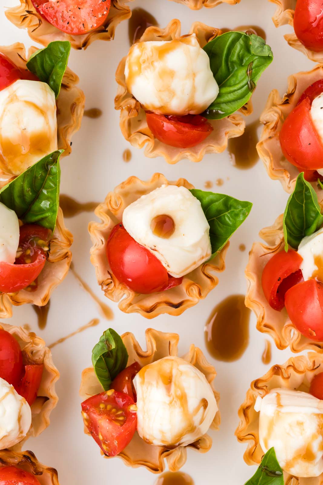 Caprese cups on a platter.