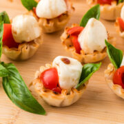 Caprese Cups on a wooden board.