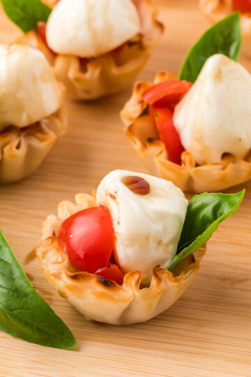 Caprese Cups on a wooden board.