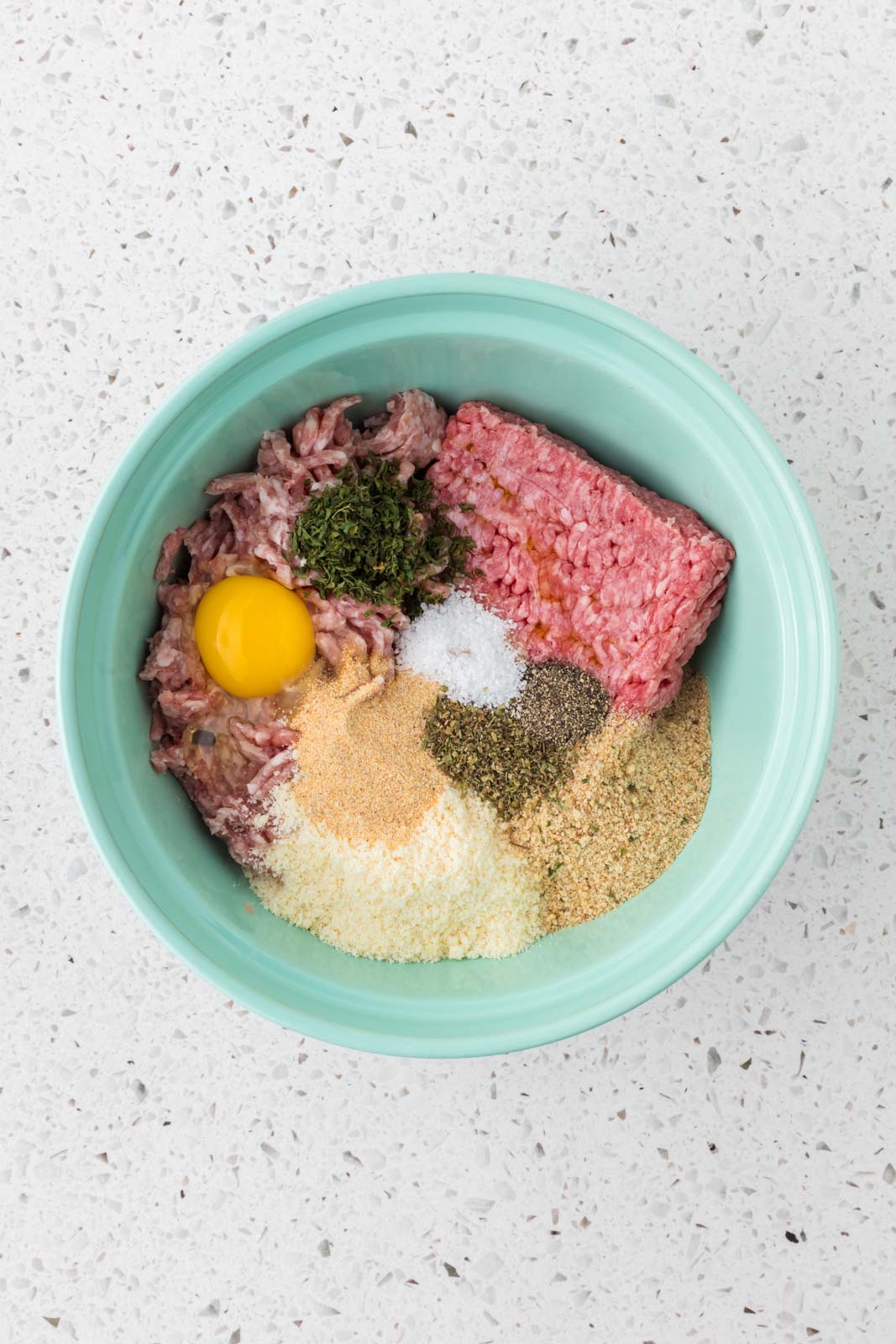 All ingredients for Italian mini meatballs in a mixing bowl.