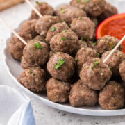 Italian Mini Meatballs on a plate with marinara dipping sauce.