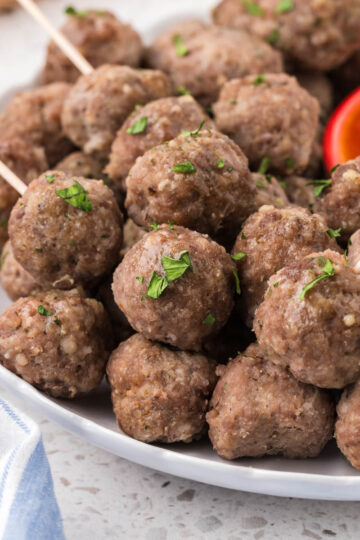 Italian Mini Meatballs on a plate with marinara dipping sauce.