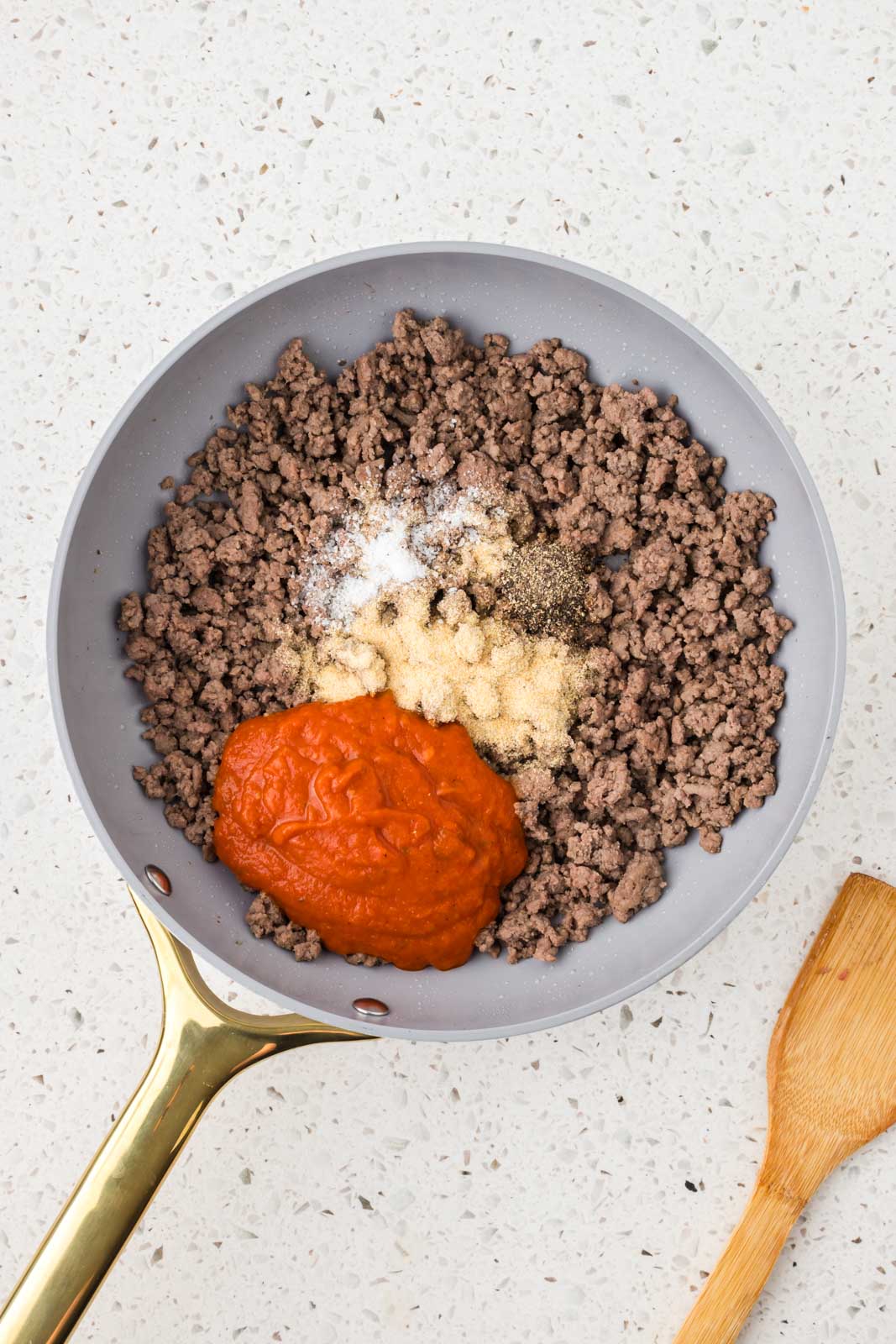 Brown ground beef, seasonings, and sauce in a sauté pan.