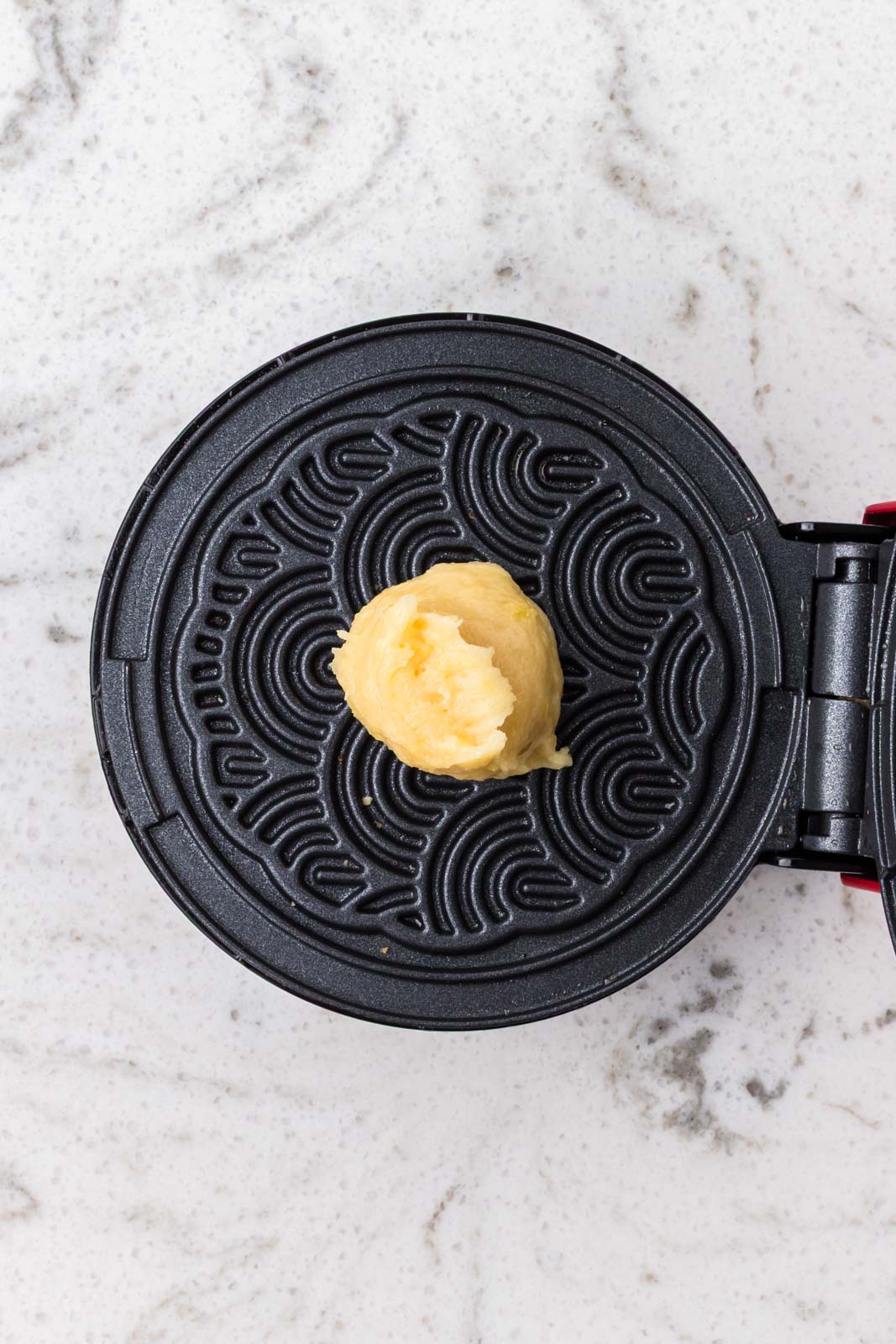 Dollop of batter on the pizzelle maker.
