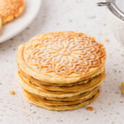 Stack of lemon pizzelle on countertop.