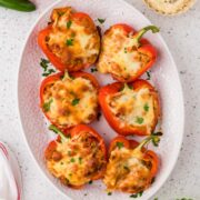 Italian chicken stuffed peppers on a platter.