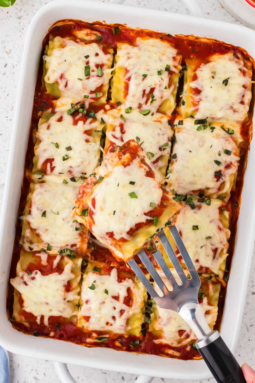Spinach Lasagna roll ups in a baking dish.