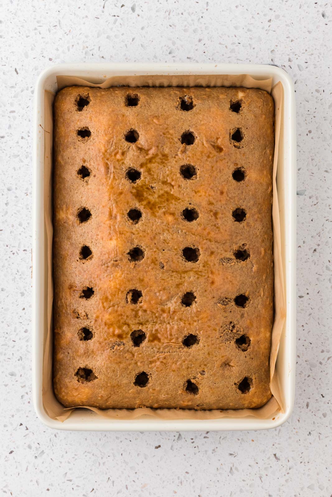 Tiramisu poke cake with espresso pour over it.