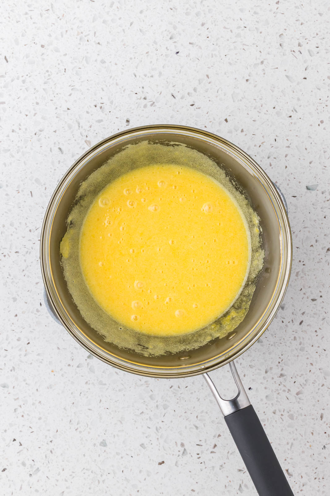 Egg yolks and sugar in a double boiler.