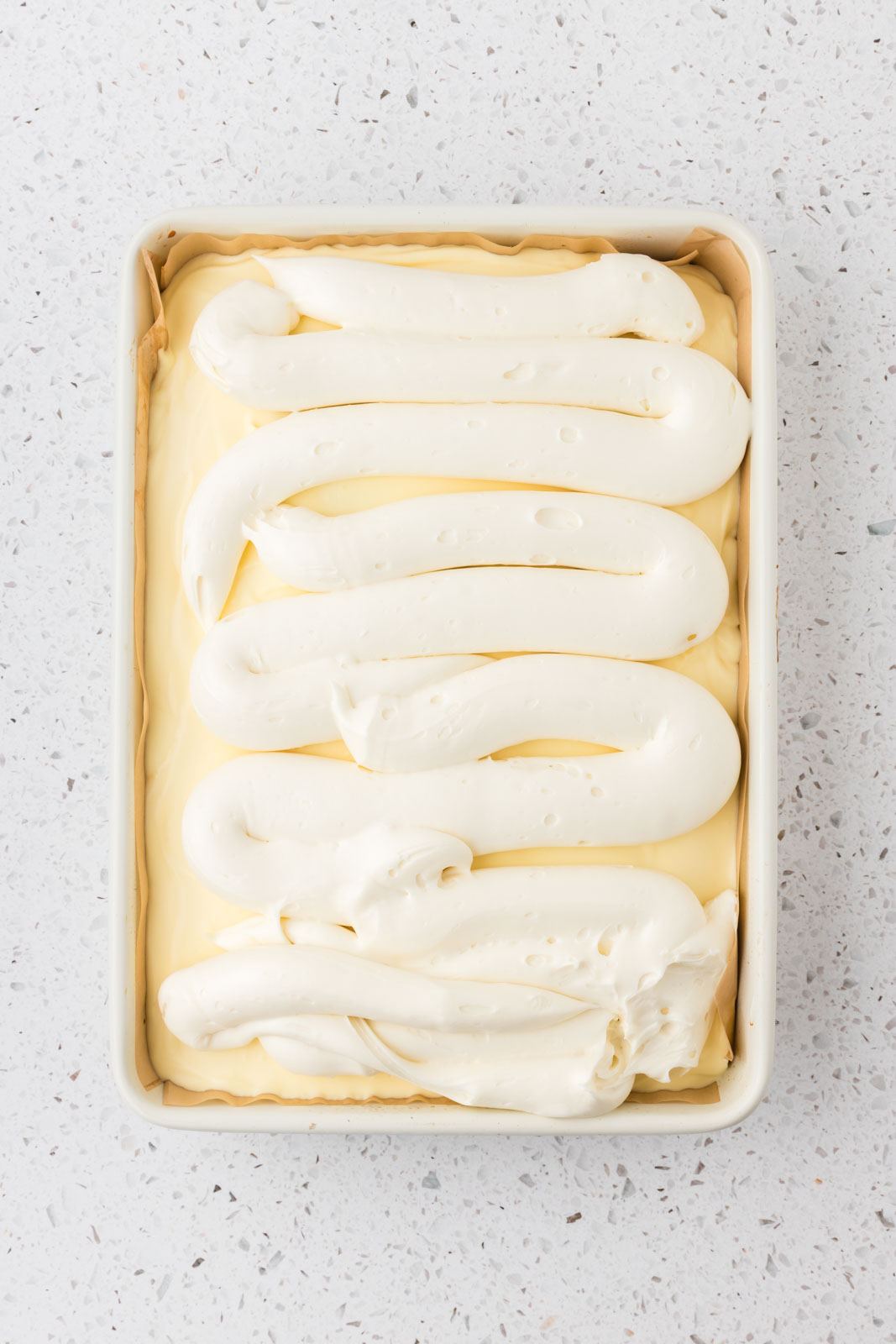 Tiramisu poke cake with mascarpone frosting.