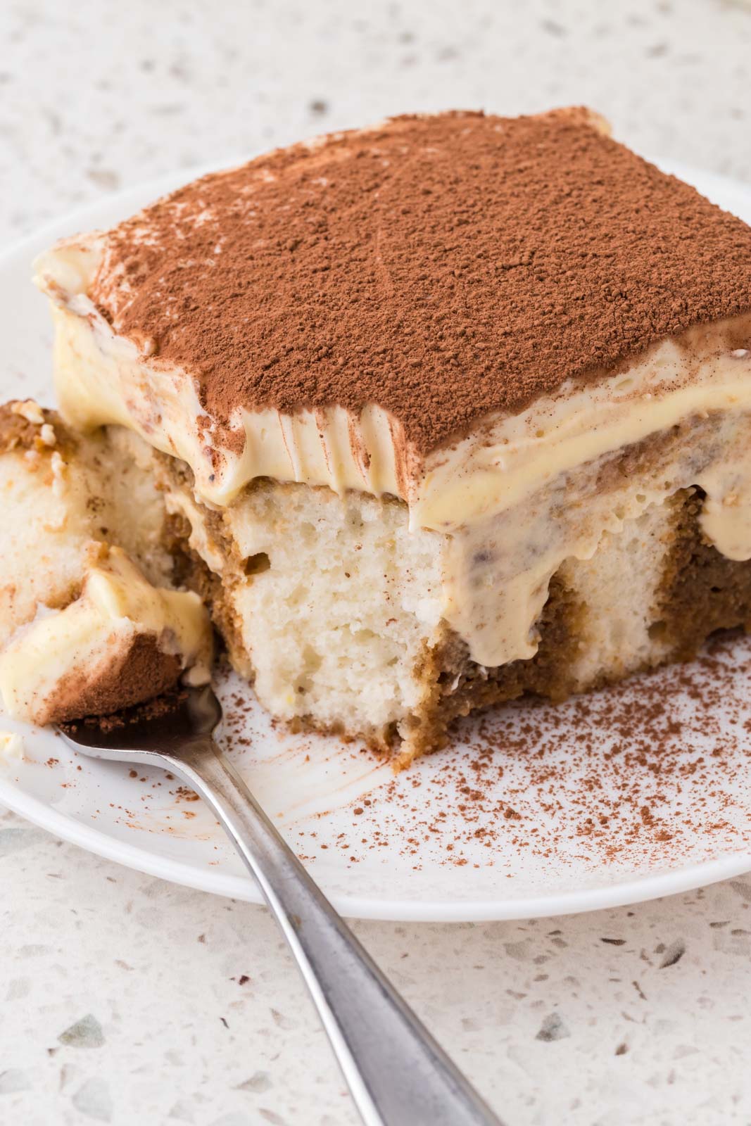 Tiramisu poke cake on a plate.