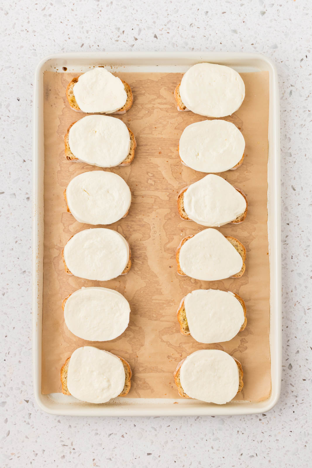 Sliced mozzarella on top of each slice of bread.