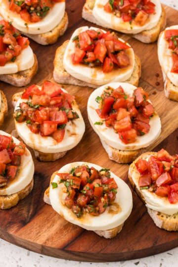 Caprese Bruschetta on a serving board.