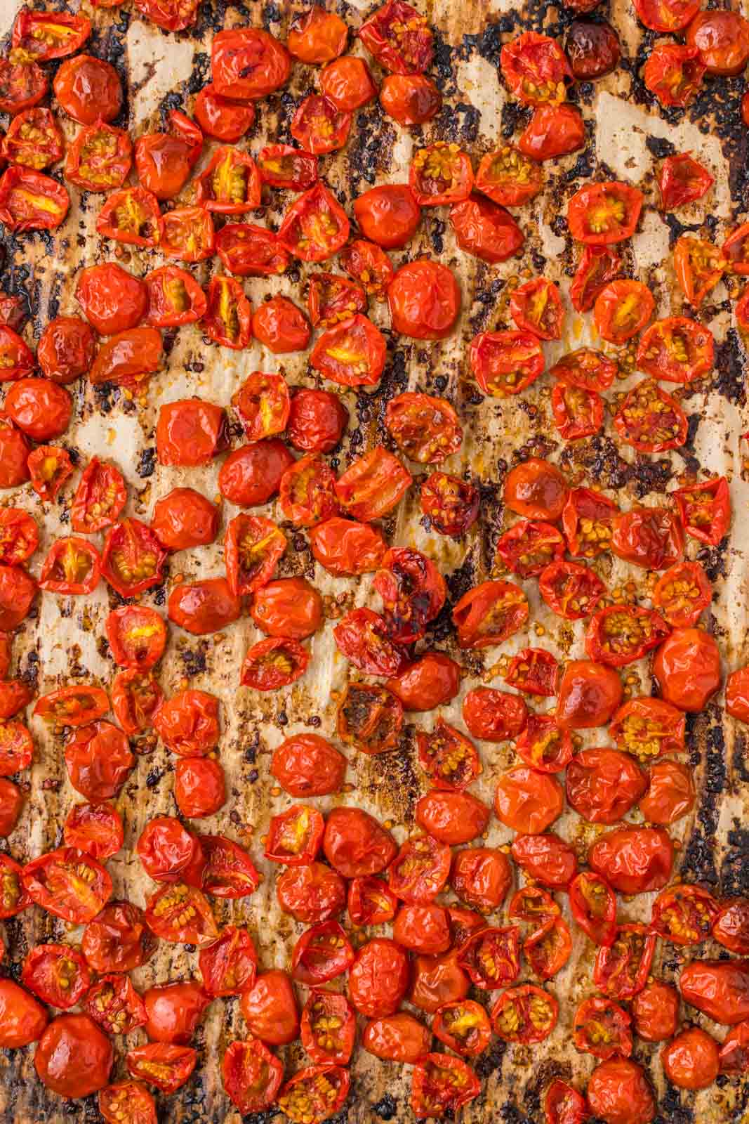 Cherry tomatoes roasted on a sheet pan.