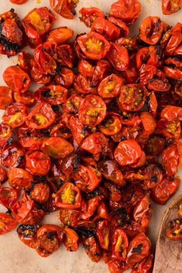 Roasted Cherry Tomatoes on a baking sheet with parchment paper.
