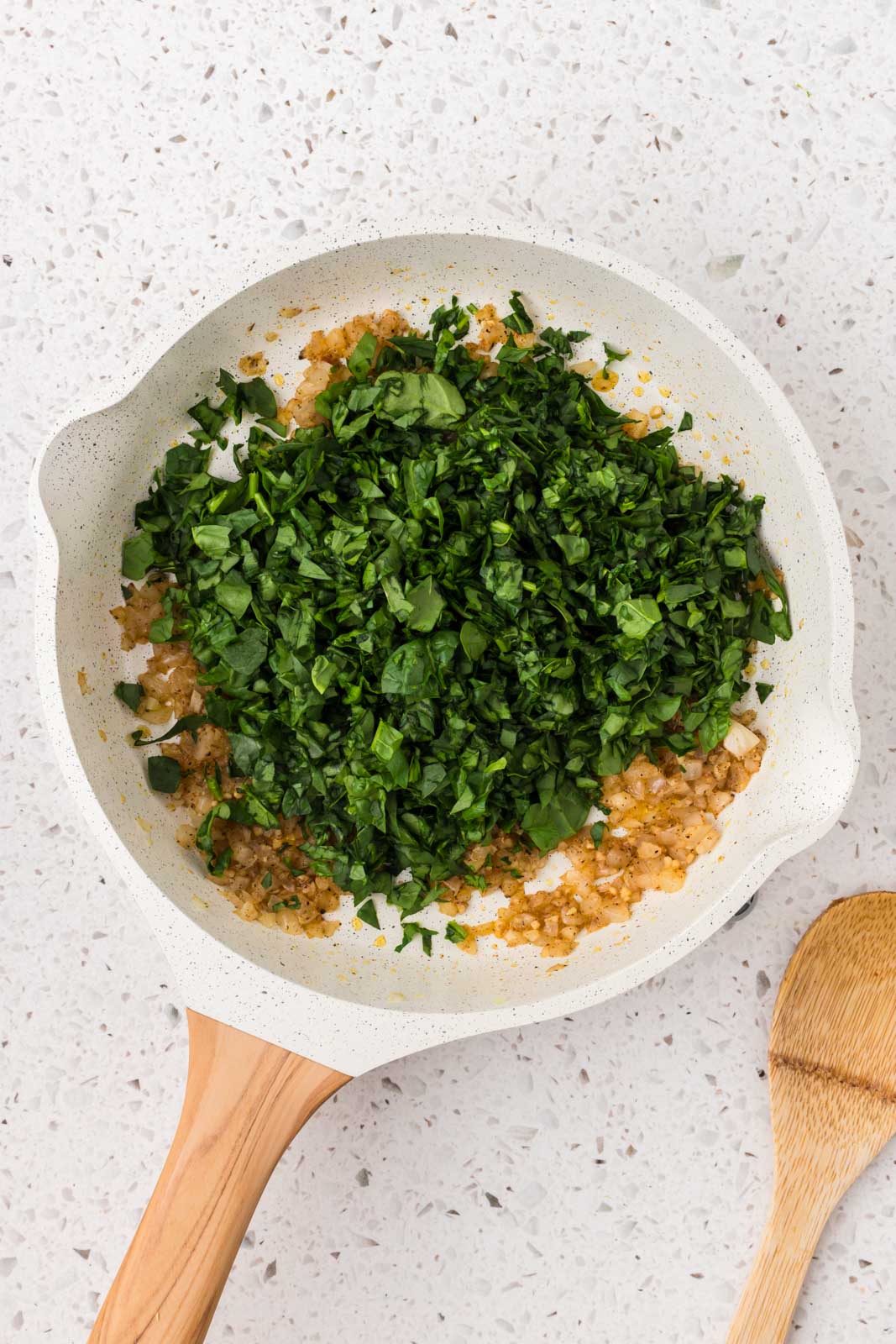 Chopped spinach added to the saute pan. 