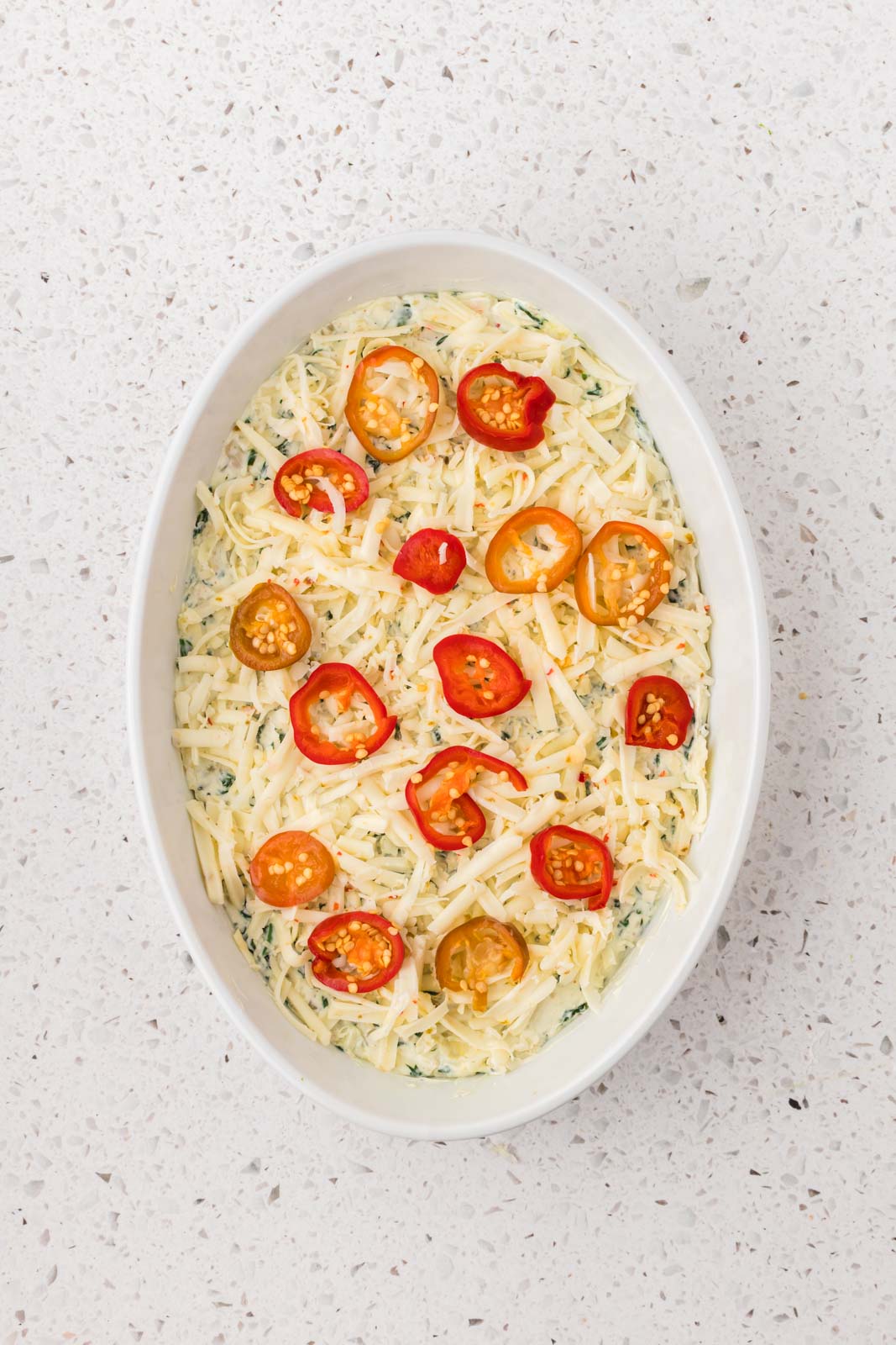 Top casserole with shredded pepper jack cheese and sliced peppers. 