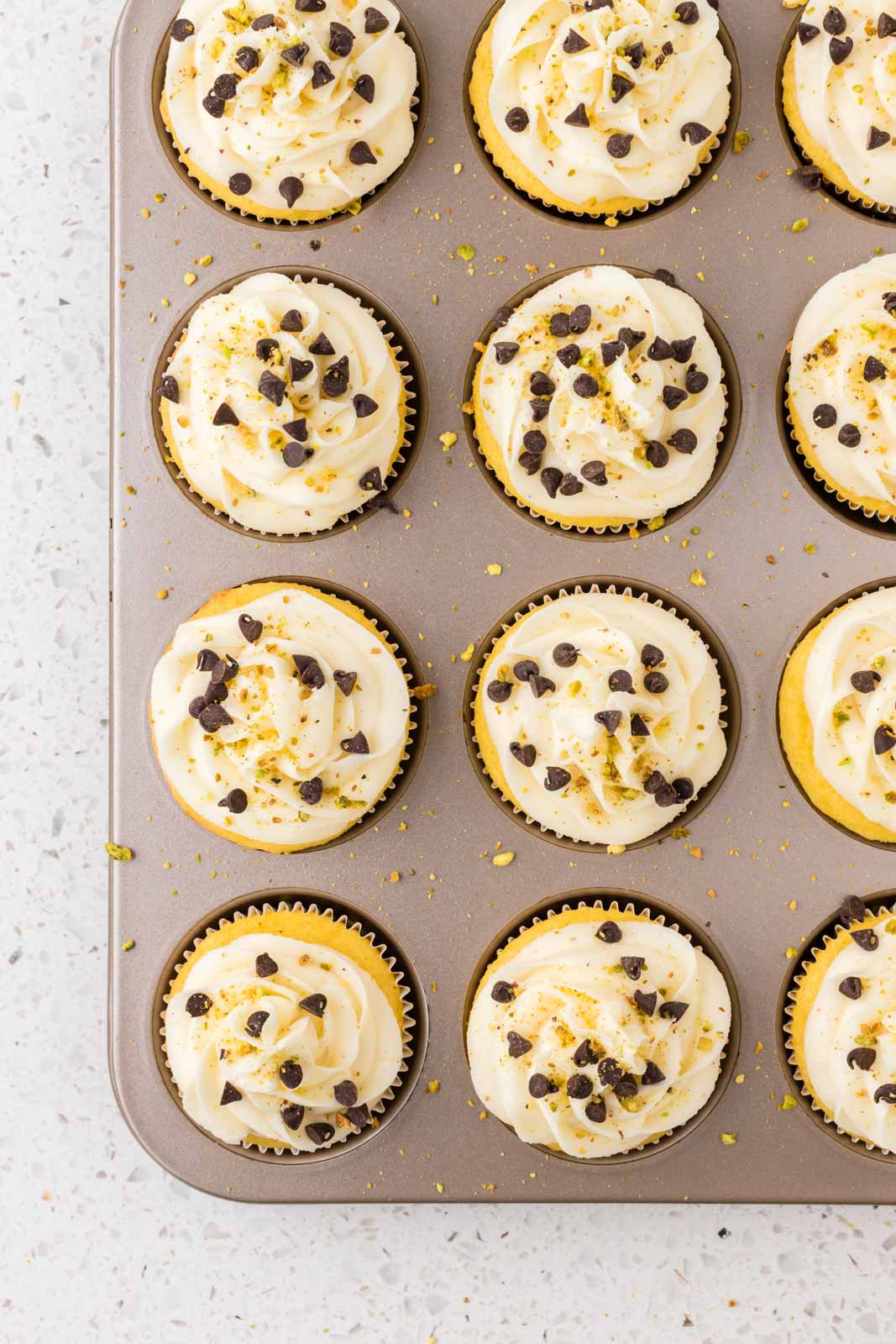 Cannoli cupcakes in a cupcake pan.