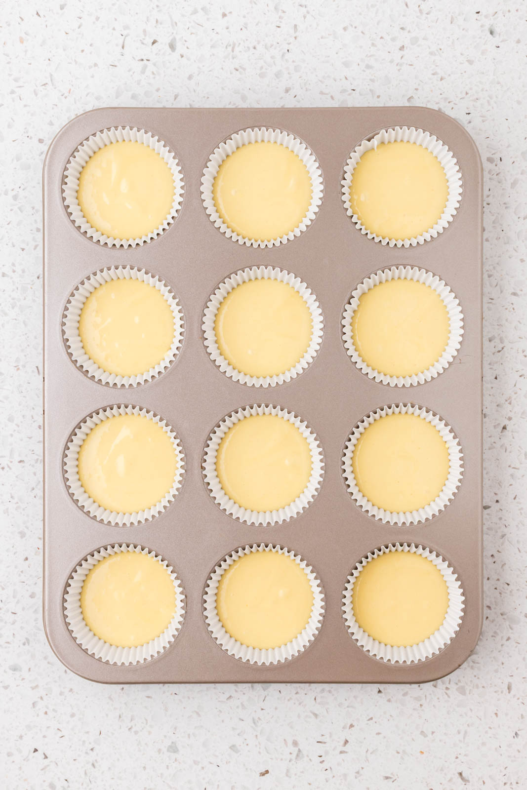 Cannoli cupcake batter in cupcake liners.